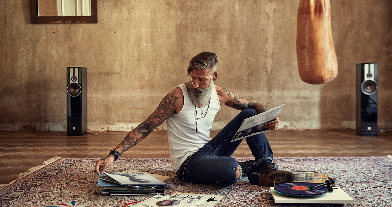 Man with vinyl records and hi-fi speaker