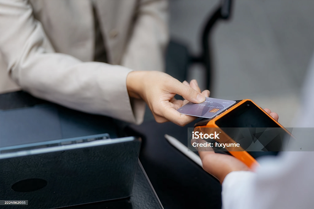 Customer tapping a card on a payment terminal